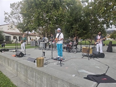 Musicians playing on cement stage at Memorial Park