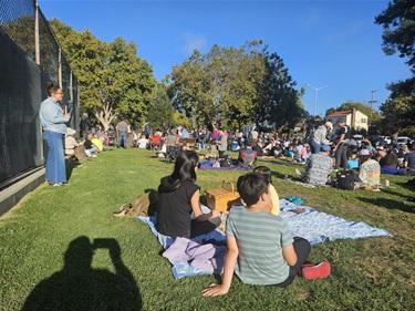 Crowd gathered on grass at Concert in the Park